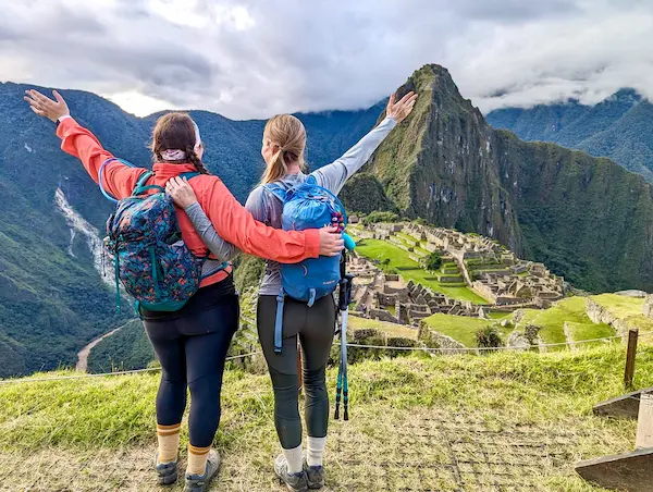 Two women enjoying their trekking adventure at Machu Picchu, Peru.