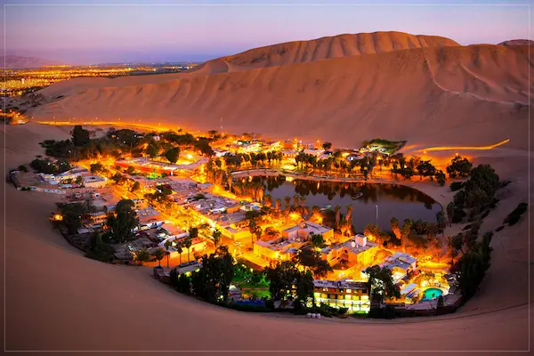 The breathtaking Huacachina Oasis at night in Ica, Peru.